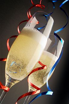 Two champagne glasses with red and blue streamers